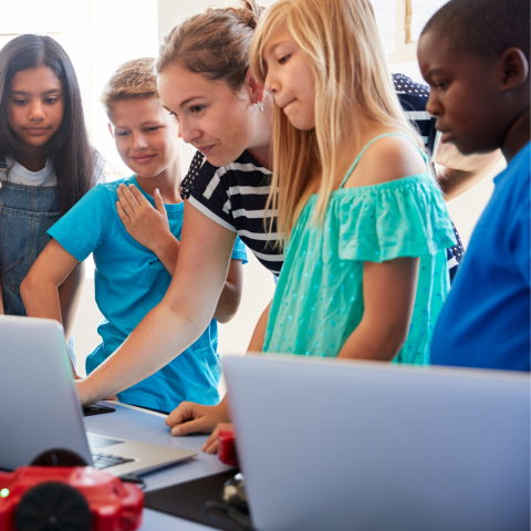 Group of young people working together using computers.