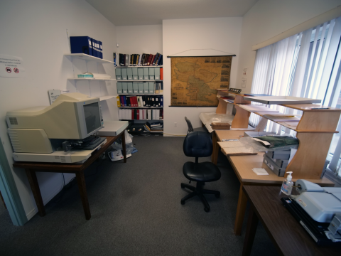 Wellington Archives Reading Room with archival equipment and a map of Prince Edward County on the wall.