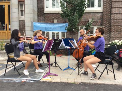 a group of musicians plays outside the Picton Branch Library