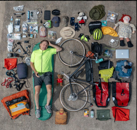 Phil surrounded by equipment and his bicycle